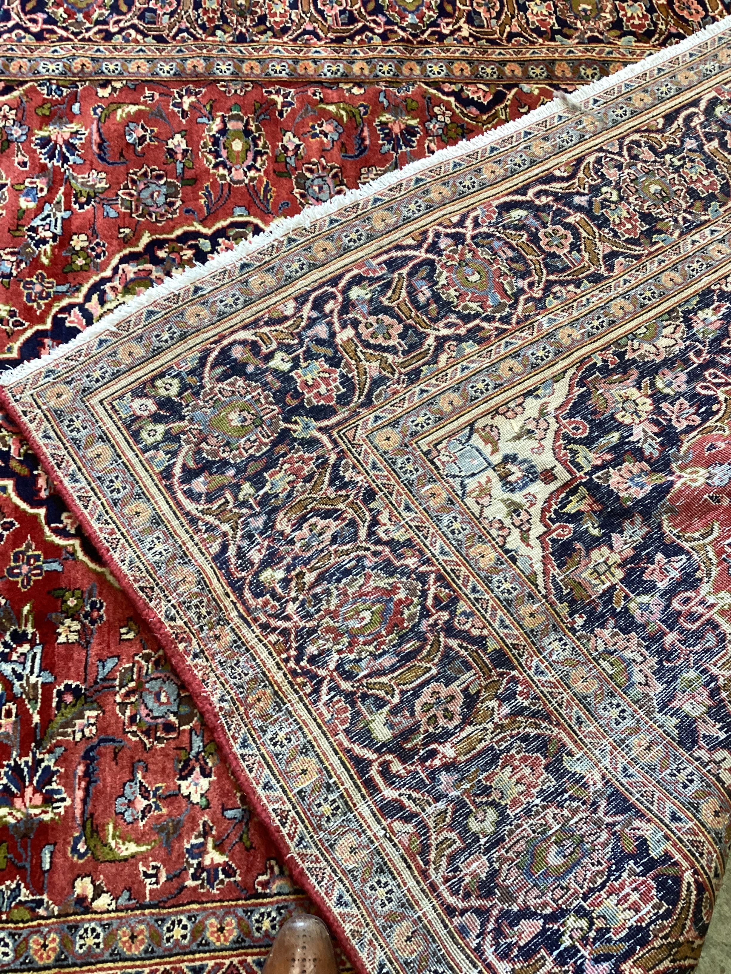 A Kashan brick red ground carpet, approx. 300 x 195cm